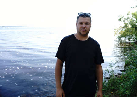 Handsome guy takes a selfie at the beach - people, lifestyle and technology conceptの写真素材