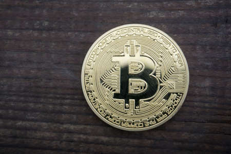 golden bitcoin on wooden backgroundの写真素材