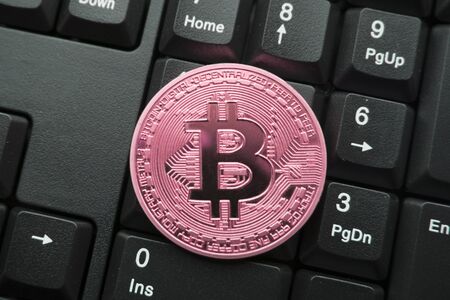 golden bitcoin on keyboardの写真素材