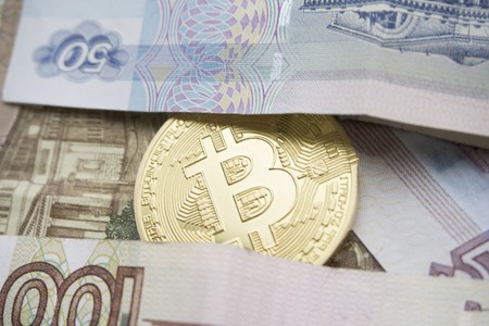 One Bitcoin on Russian banknotes. Closeup, macro shotの写真素材