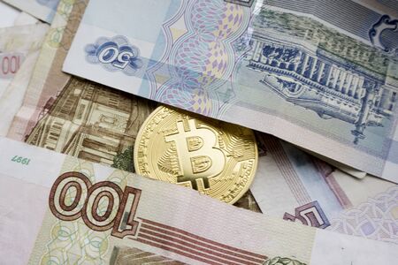 One Bitcoin on Russian banknotes. Closeup, macro shotの写真素材