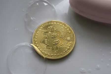 bitcoin in a soap bubble on background with sun lightの写真素材