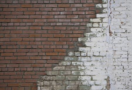 Repair of old brick wall with new white stones White stone wall and plastered red brick wall for background or texture Masonry with different stones Bricklayingの写真素材