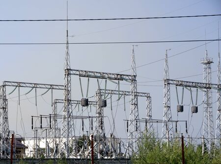 high-voltage lines against the background of electrical distribution stations at sunrise.