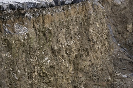 Side of the broken asphalt road collapsed and fallen, since the groundの写真素材