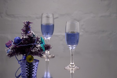 Two glasses of champagne with Christmas tree branchの写真素材