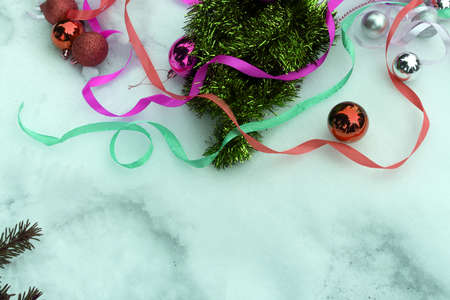 Top view on frame from Christmas decorations, gift boxes, fir branches and pine cones on the blue background with copy space.の写真素材