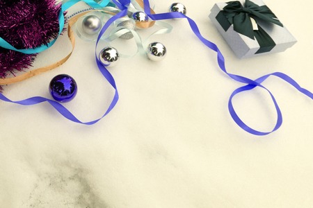 Red metallic bow at a christmas tree with coloured lightsの写真素材