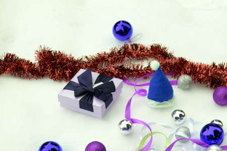 Christmas colorful balls and fir branch on white snow backgroundの写真素材