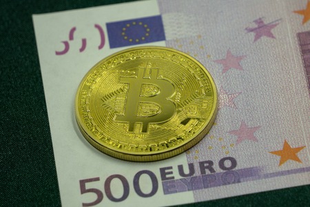 Golden Bitcoin and Silver Bitcoin on Euro Banknote background,の写真素材
