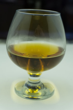 Scotch on wooden background with copyspace. An old and vintage countertop with highlight and a glass...