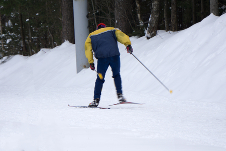 Ski slope in the background and the skier with the equipmentの写真素材