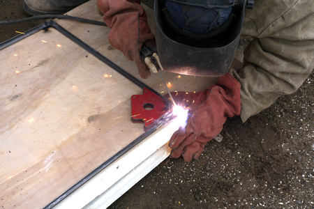 The welder cooks the frame. The welder cooks the metal. The welder cooks metal structures. Welding...