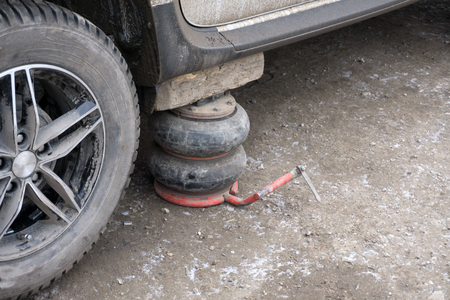automotive hydraulic Jack under the car to change the wheelの写真素材