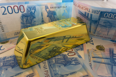 Gold bars on dollar banknotes, close upの写真素材