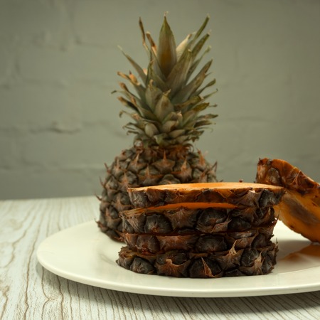 Sliced pineapple over white backgroundの写真素材