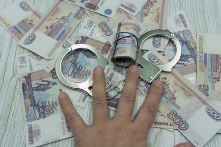 Themis and handcuffs, hammer on euro and dollar bills backgroundの写真素材