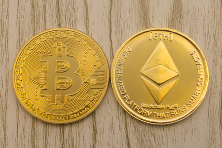 horizontal top view closeup of ethereum litecoin and bitcoin stack of golden coins background texture exchange conceptの写真素材