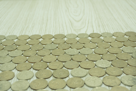 Top view coins on old wooden desk with copy space on topの写真素材