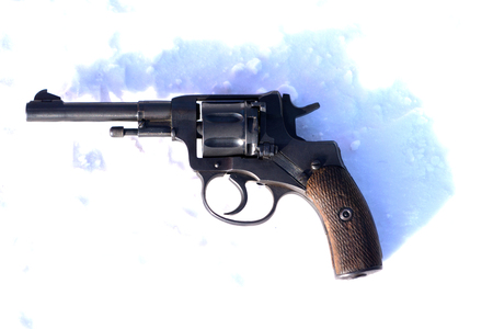 Mini Revolver with wooden grip on the blacket of snowの写真素材