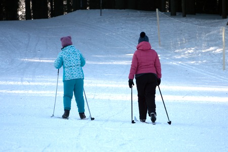 Two little boys eating on the walk in winter Parkの写真素材