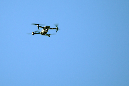 drone hovering in blue skyの写真素材