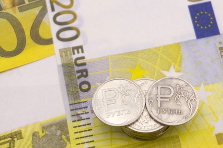 coin one ruble and the European currency: banknotes of five and fifty euro coinsの写真素材