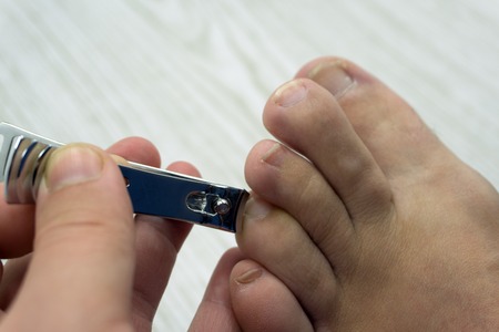 Cut toenails newborn pedicure skin treatment whiteの写真素材