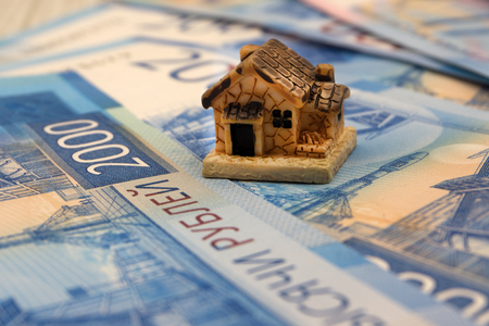 Mini house on stack of coins. Concept of Investment propertyの写真素材