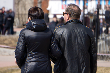 Feeling excitement. Elegant old woman is going under the handle with her husband. She is looking at him with happy smile while exiting from airport building. Copy space in the left sideの写真素材