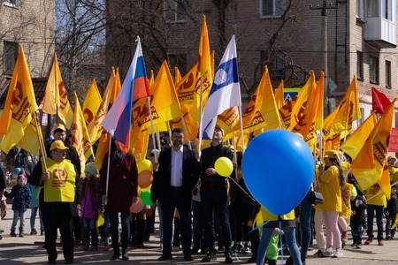Berezniki, Russia, on 1 may .2018: many football fans are going to the match with yellow flags are...