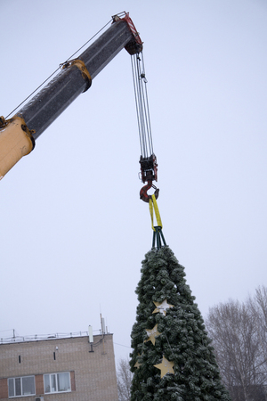 dismantling the Christmas tree with a machine crane workingの写真素材