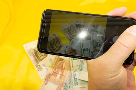 Businessman using smartphones to take photos of document and diagram business chart .の写真素材