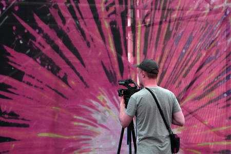 Covering an event with a video camera., Videographer takes video camera with free copy space for text., Video camera operator working - Russia Berezniki 15 July 2017のeditorial素材