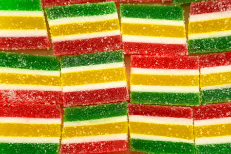 Colorful candies, jelly and marmalade on stone background. Top view with copy space