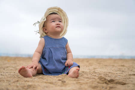 asian baby on the beachの写真素材