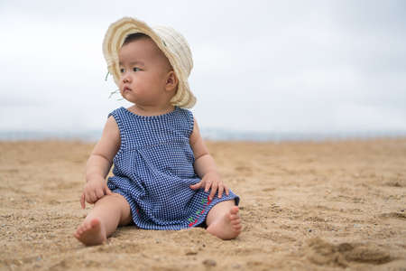 asian baby on the beachの写真素材