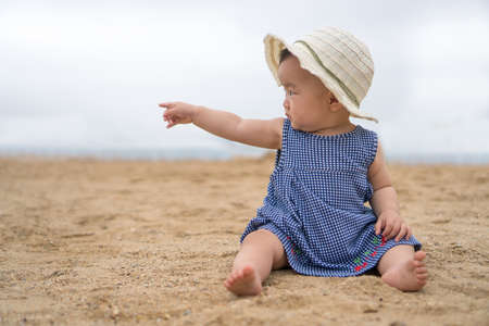asian baby on the beachの写真素材