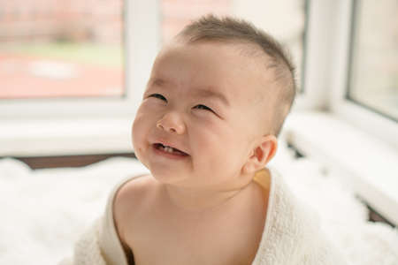 baby with towelの写真素材