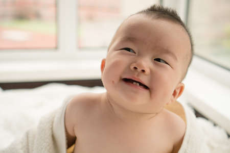 baby with towelの写真素材