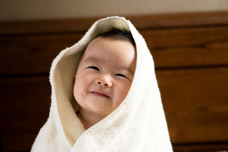 baby with towelの写真素材