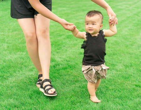 baby learning walkingの写真素材