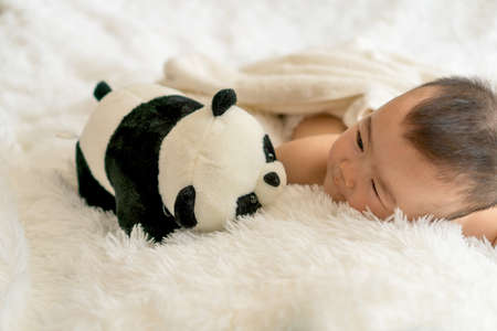 baby with panda toyの写真素材