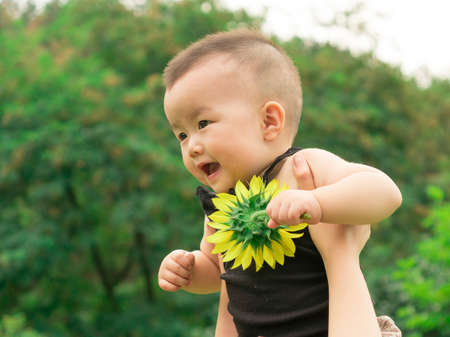 mother lifting baby upの写真素材
