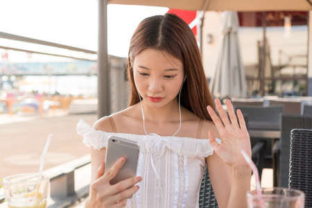 asian girl hand holding a smartphoneの写真素材