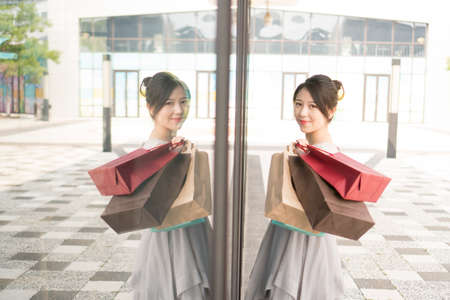 asian girl with shopping bagsの写真素材