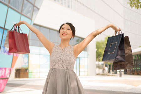 asian girl with shopping bagsの写真素材