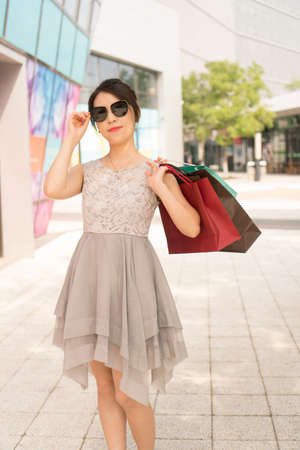 asian girl with shopping bagsの写真素材