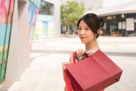 asian girl with shopping bagsの写真素材