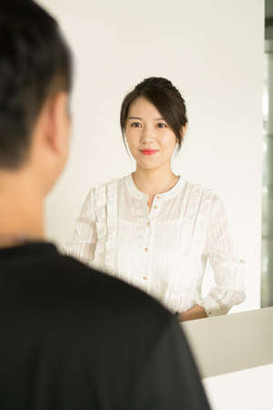 office lady looking into the mirrorの写真素材